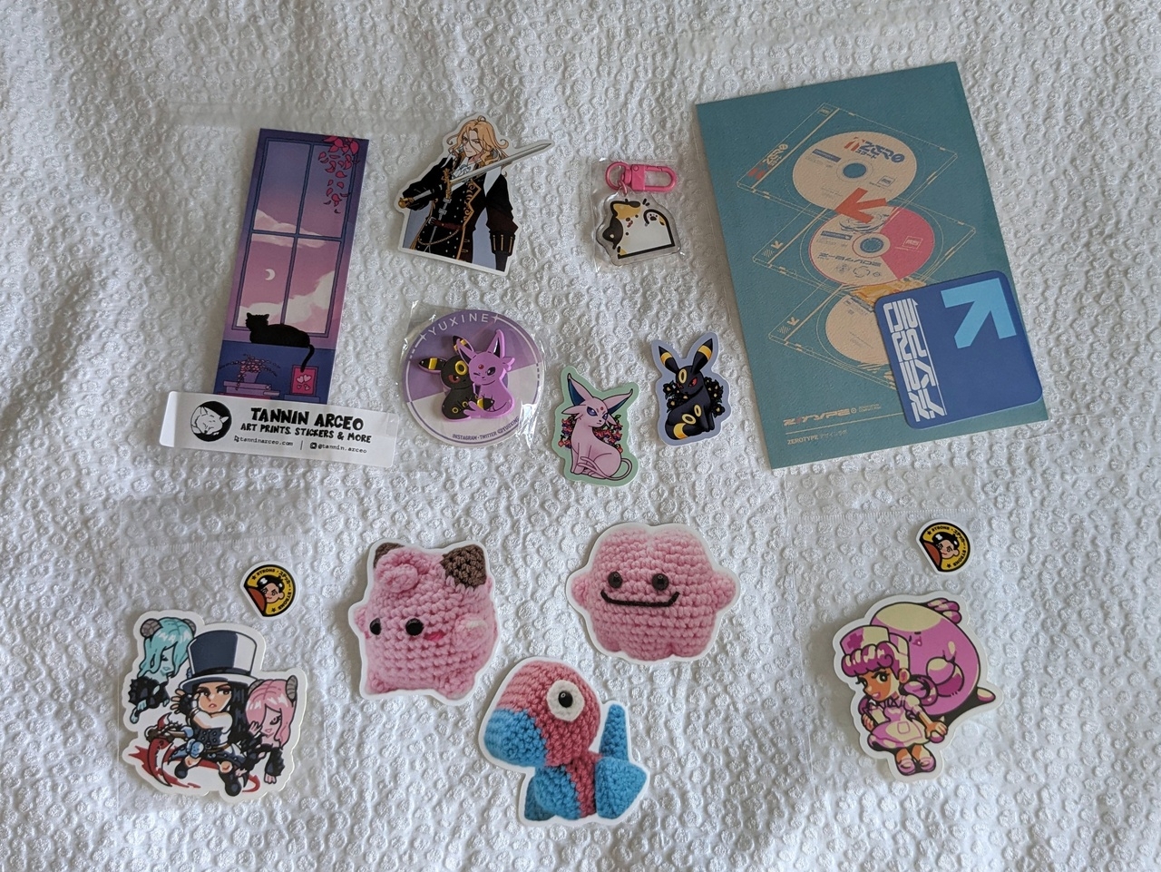 an assortment of stickers and prints, mostly cute kitties and Pokemon stickers