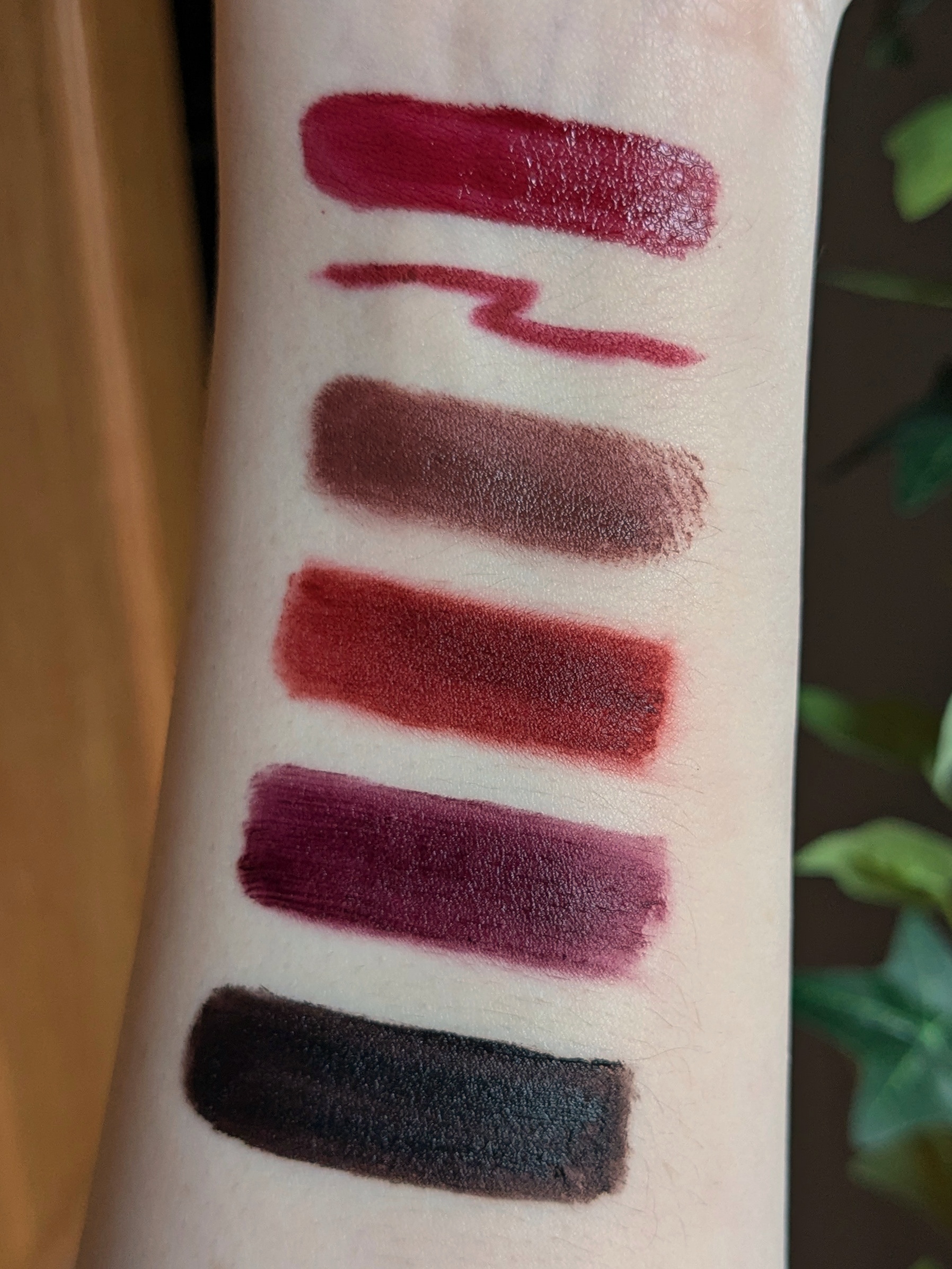 photo: each of the lipstick colors mentioned, swatched together on Tulip's arm